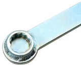 Retainer for flat belt tensioners